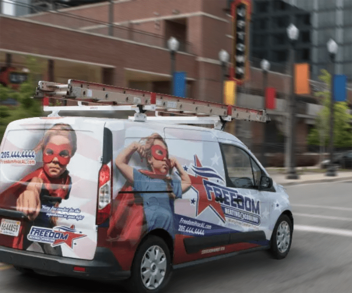 Freedom Heating & Cooling's truck zooms down a street in Uptown Birmingham, AL